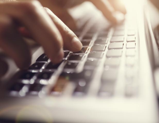 Fingers typing at keyboard