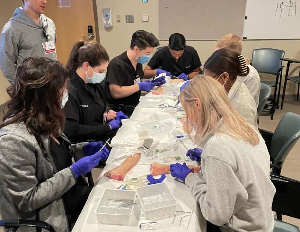 Group of residents in procedure lab for emergency medicine.