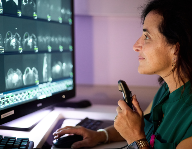 Dr. Robin Roth reviews breast images on monitor at her desk. 
