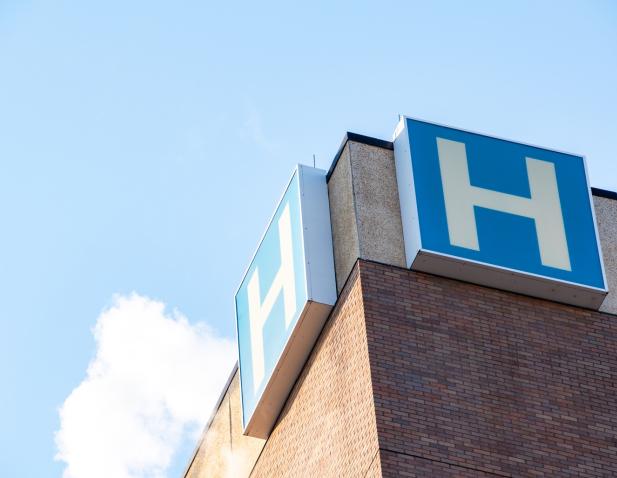 Hospital "H" on blue background from Kelemen Building exterior
